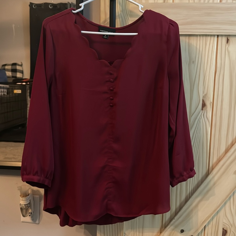 Boutique style long sleeve blouse with scalloped V-neck and button details
